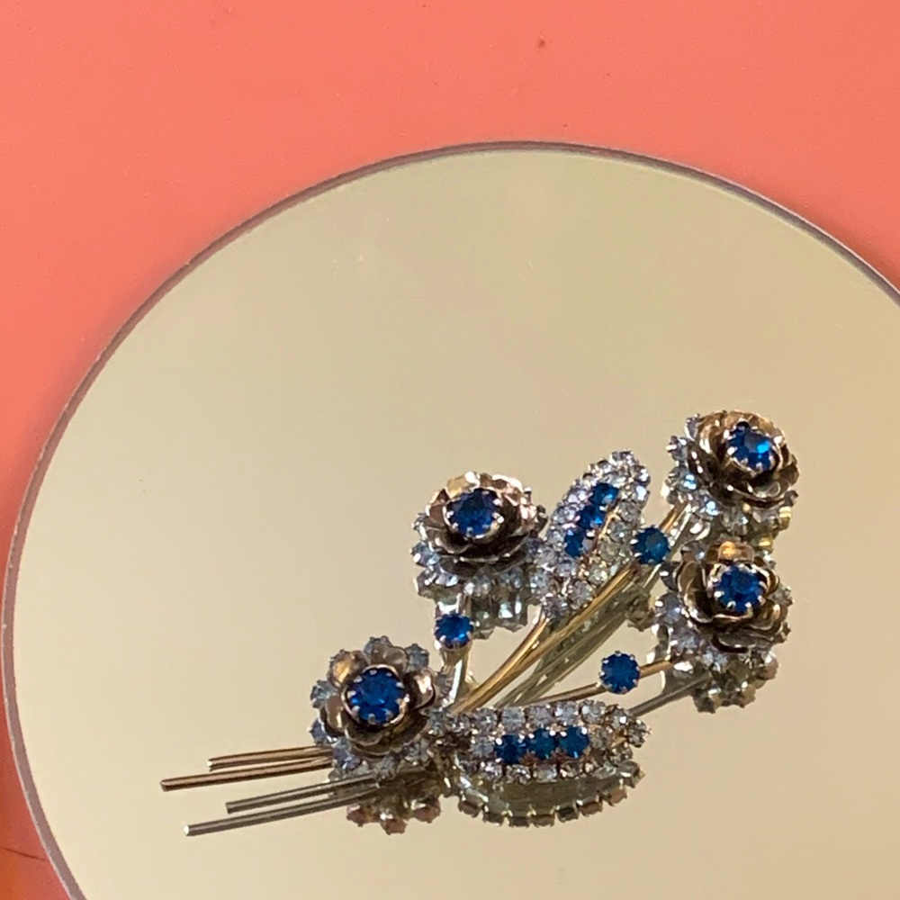 Silver and blue gemmed flower broach